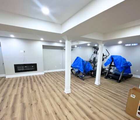 Grey vinyl flooring with built in tv wall, wet bar