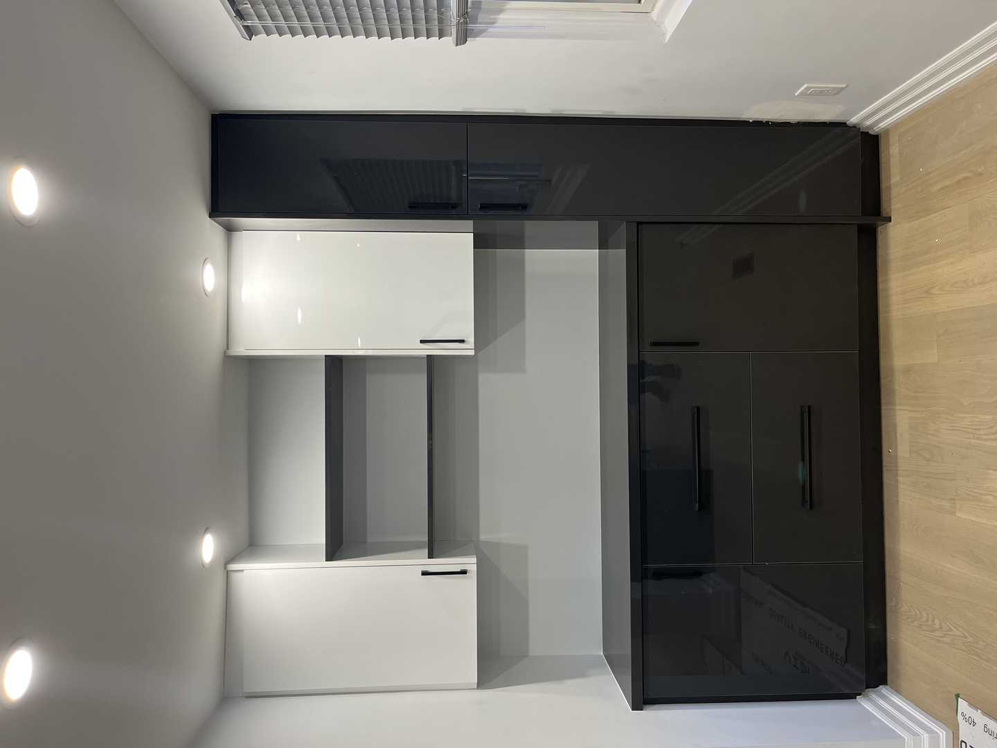 Black and white glossy finish walk-in pantry with black handles. - Image 4