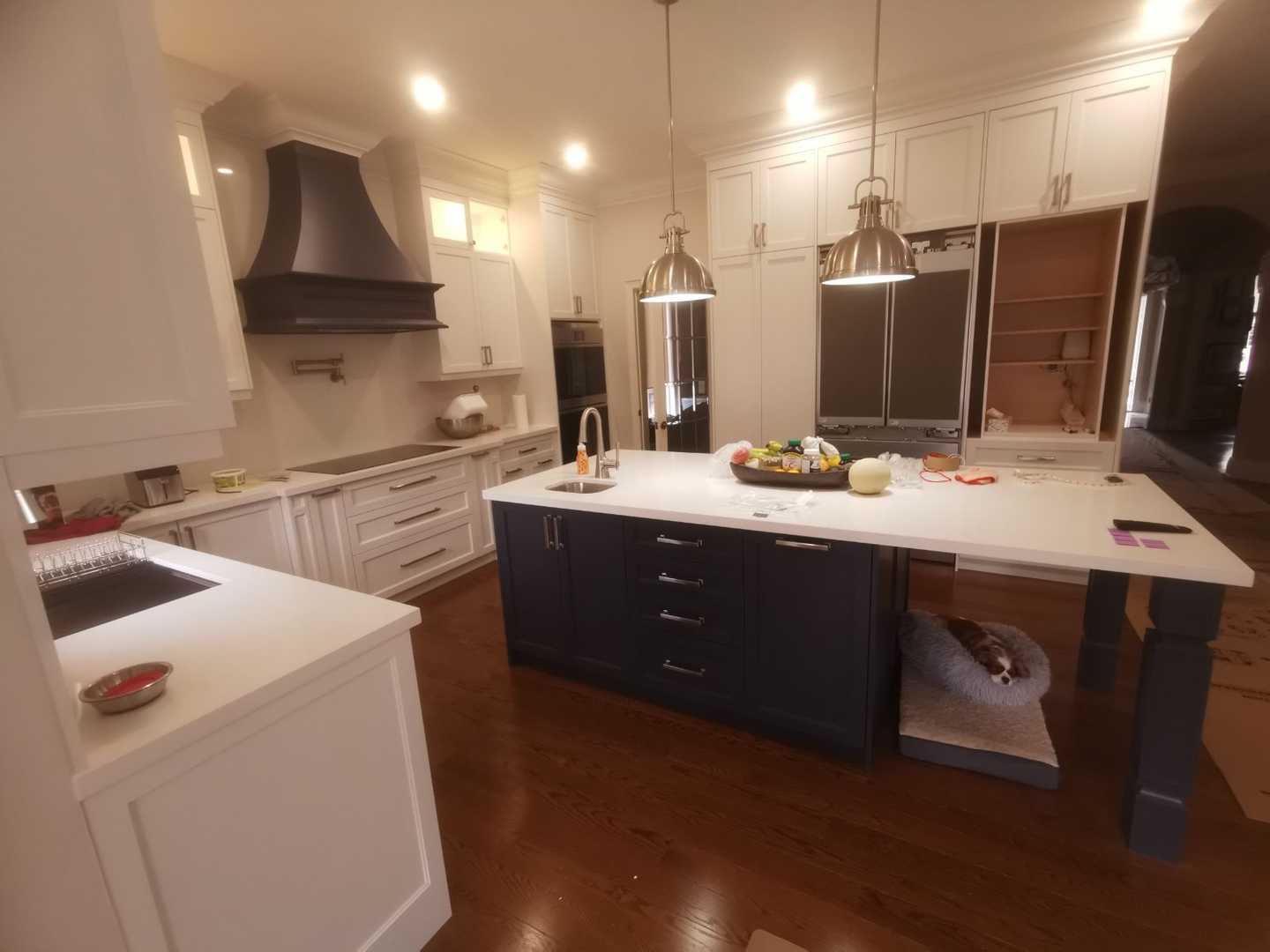 Complete home renovation with a statement wavy-textured fireplace wall. Kitchen - Image 3